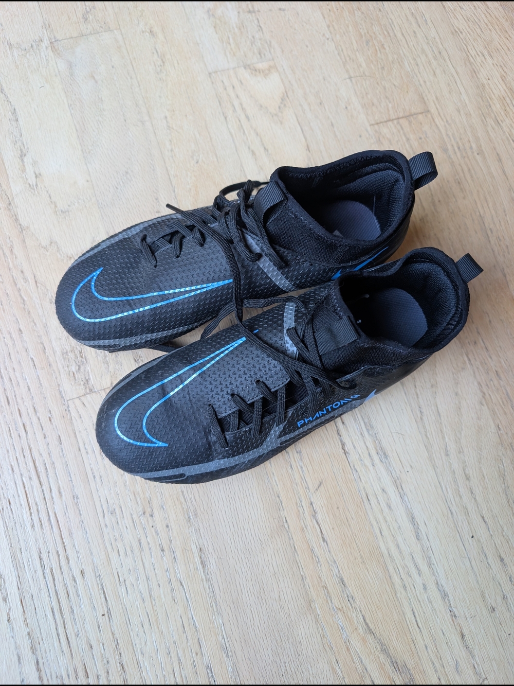 Nike Kids Black Athletic Shoes with Blue Swoosh